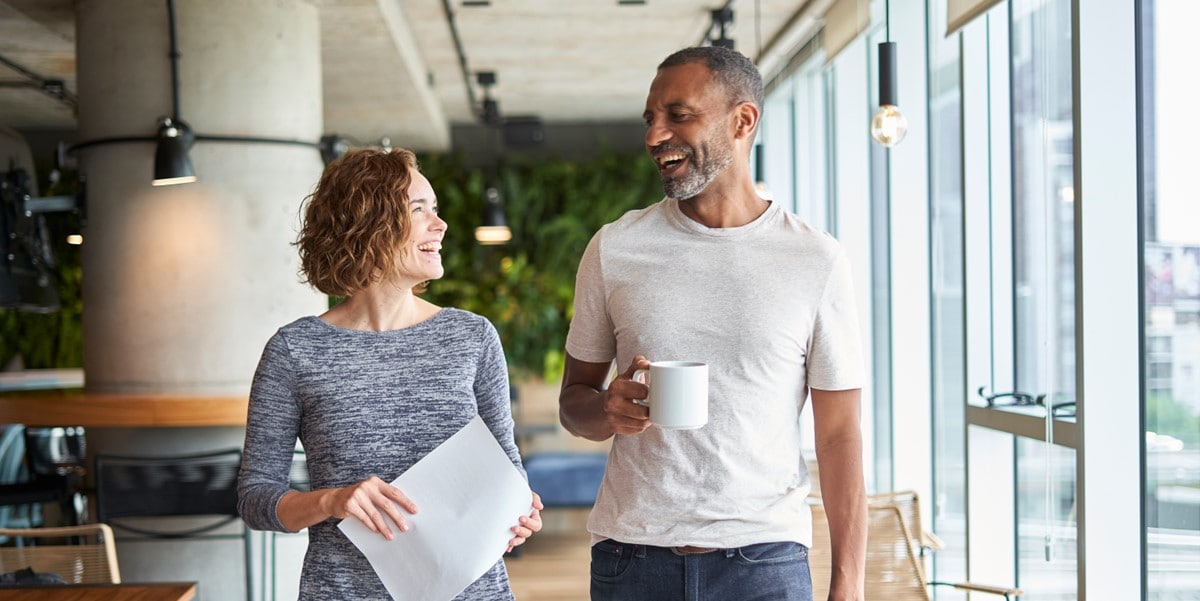 2 people walking through office