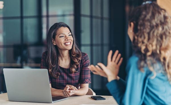 women collaborating in office