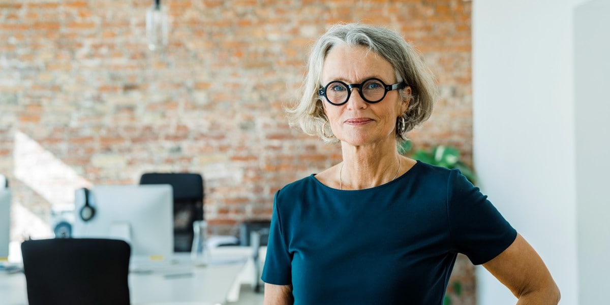 professional woman smiling, in the office