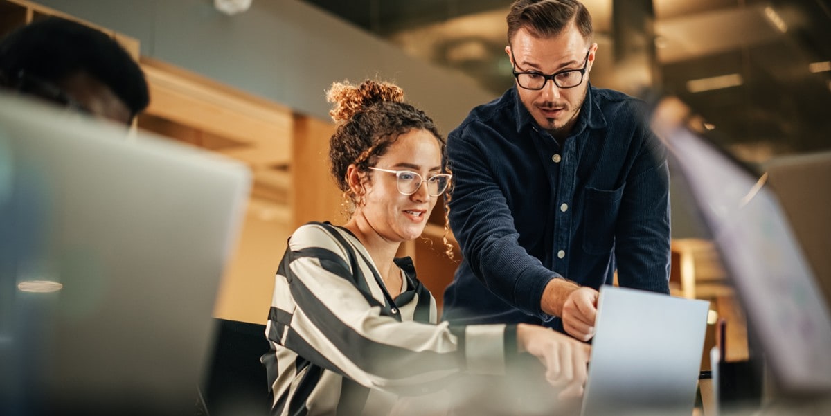 professionals in office looking at computer