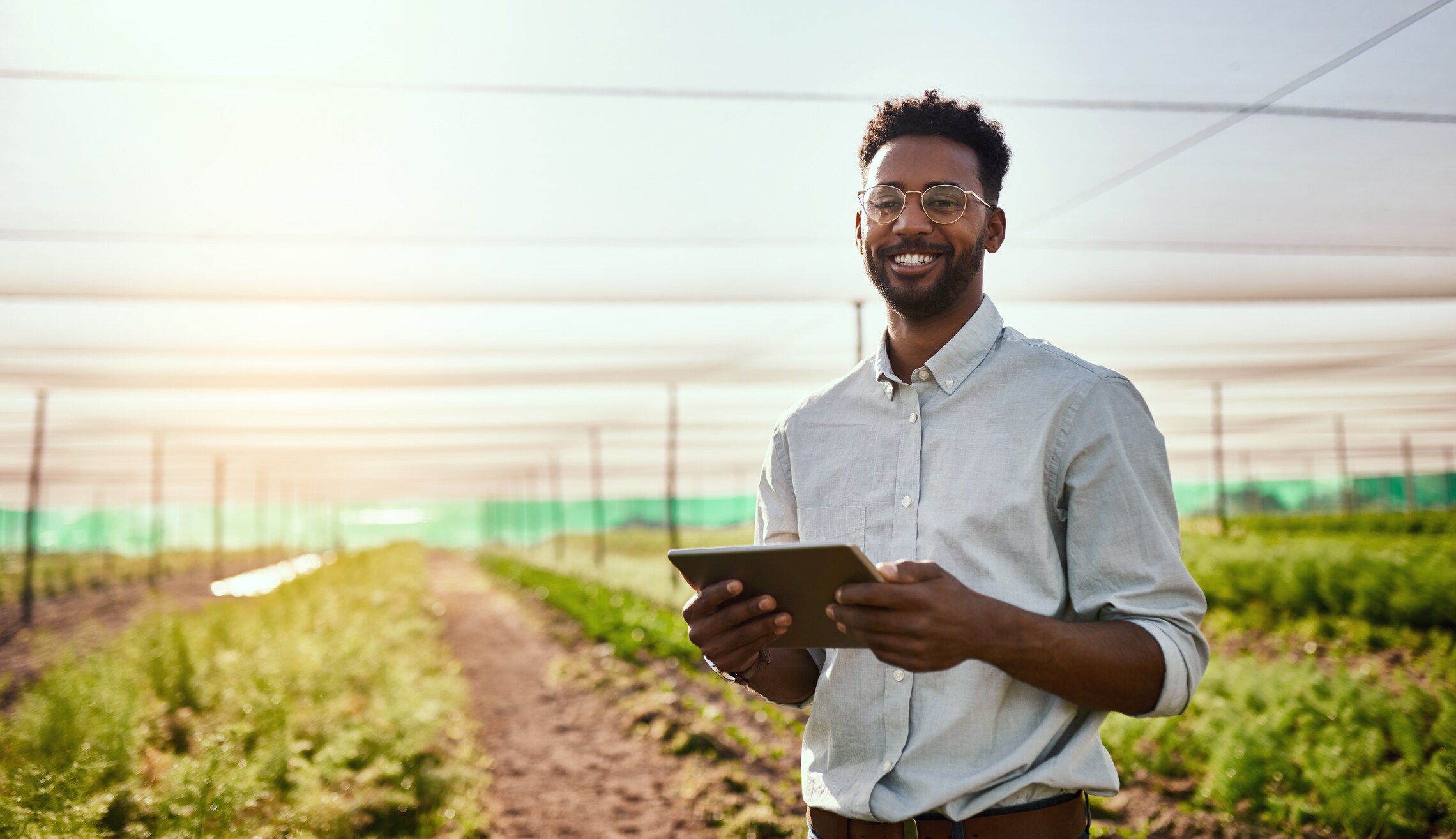 man in the field on ipad