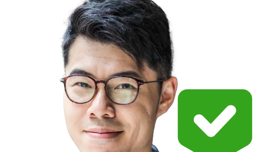 Man standing next to green checkmark
