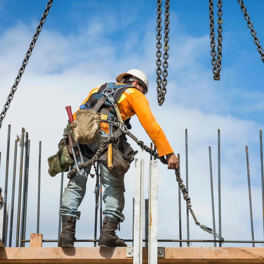 Caucasian worker holding chain at construction site